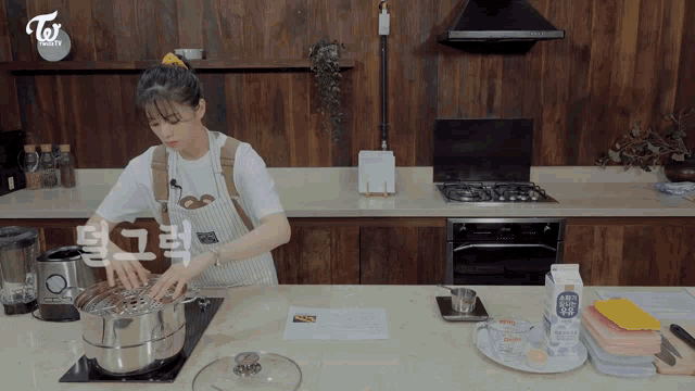 a woman in an apron is cooking in a kitchen with a sign that says twice