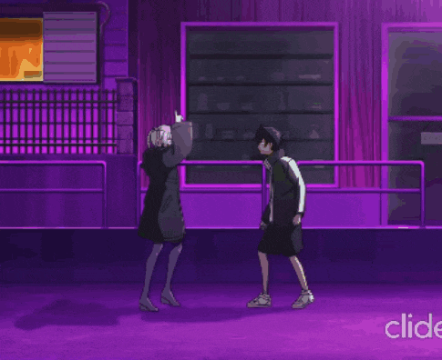 a man and a woman are standing next to each other in front of a purple building ..