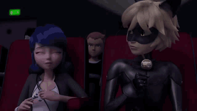 a couple of cartoon characters are sitting in a theater covering their faces