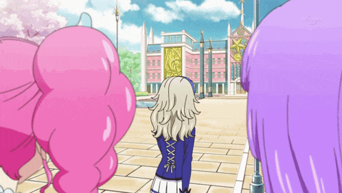 a girl with purple hair is standing in front of a building with the letter x on her back