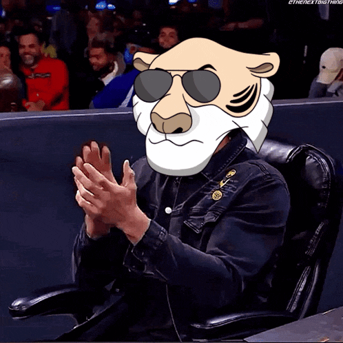 a man wearing a cartoon tiger head and sunglasses is clapping