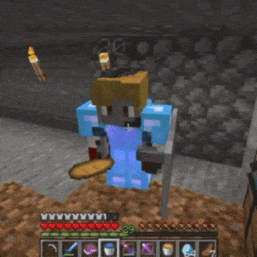 a minecraft character is holding a torch and wearing blue armor