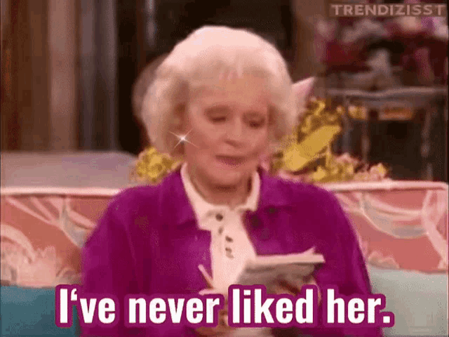 a woman is sitting on a couch and says i 've never liked her