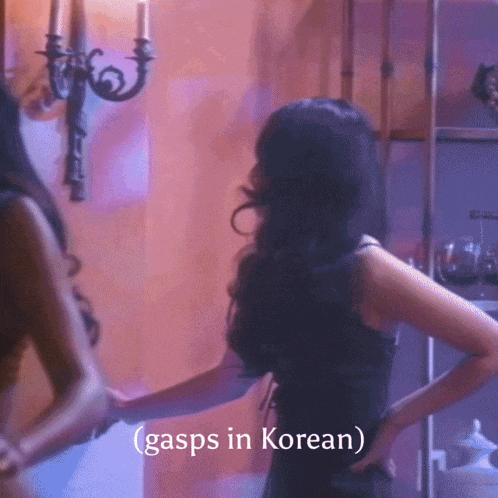 a woman in a black dress stands in front of a wall with the words gasps in korean