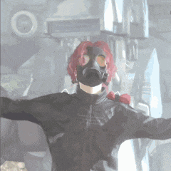 a person wearing a gas mask with red hair