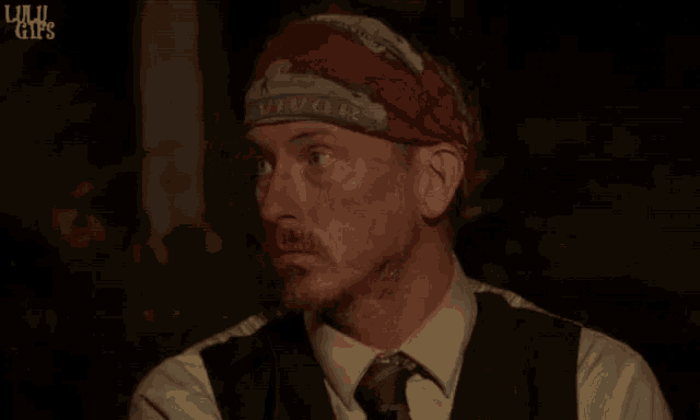 a man with a bandana on his head that says survivor