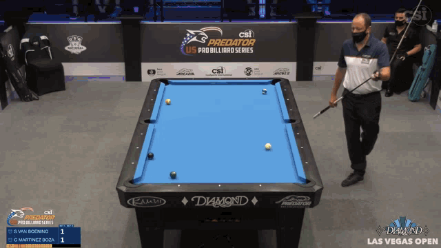 a man is playing pool in front of a diamond pool table
