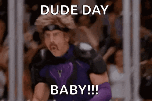 a man in a purple suit is standing in front of a crowd and says dude day baby !!!