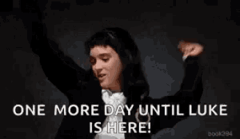 a woman in a tuxedo and bow tie is dancing and says `` one more day until luke is here '' .