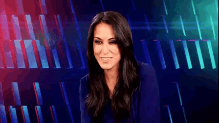 a woman is smiling in front of a blue background .