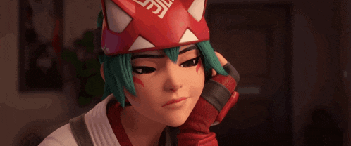 a girl with green hair is wearing a red and white cat mask
