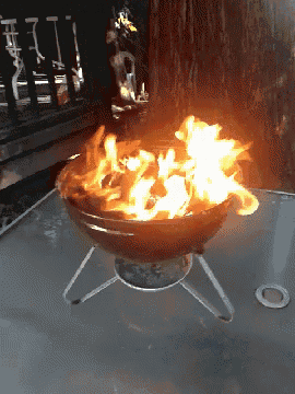 a fire is burning in a bowl on a table