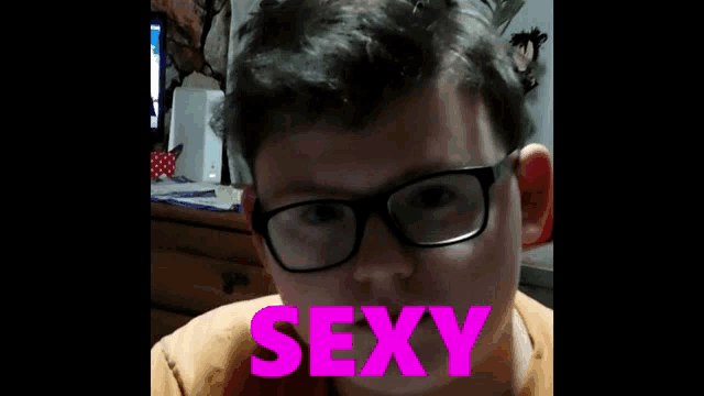 a man wearing glasses is upside down and the word sexyboy is on the bottom right