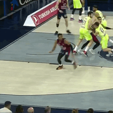 a group of basketball players are playing on a court with a turkish airlines banner in the background