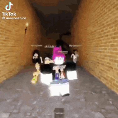 a person is standing in a hallway with a brick wall .
