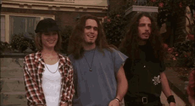 a man with long hair is wearing a black shirt that says metallica on it