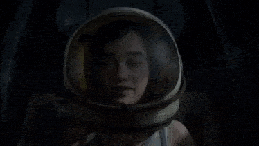 a woman wearing a helmet with her eyes closed