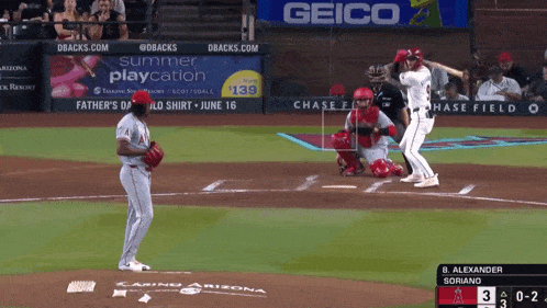 a baseball game is being played in front of a geico sign