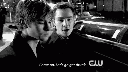 a couple of men are standing next to each other in front of a limousine .
