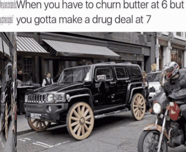 a black car with gold wheels is parked on the side of the road