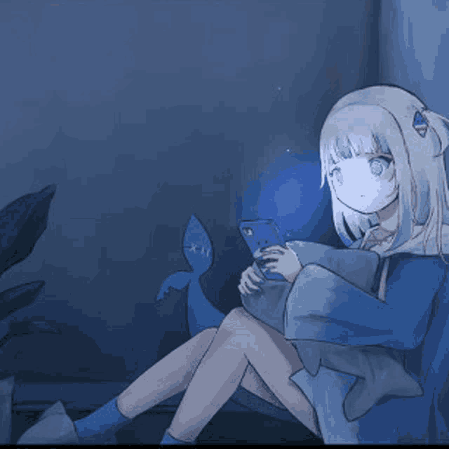 a girl in a blue dress is sitting in a chair holding a cell phone .
