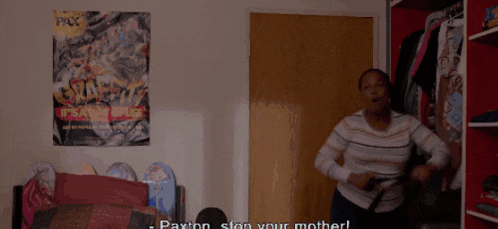 a woman is sitting in a room with a basketball on the shelf behind her .