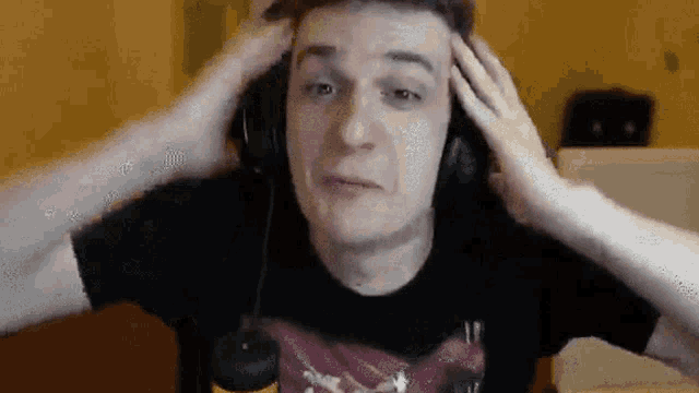 a man wearing headphones is making a funny face