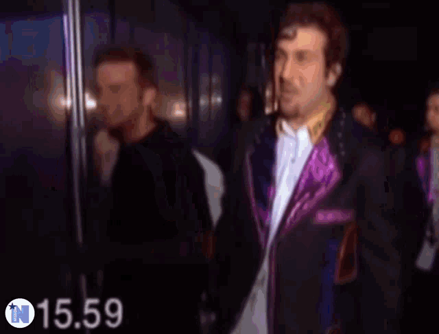 a blurry picture of a man in a blue jacket with the number 1474 in the upper right corner