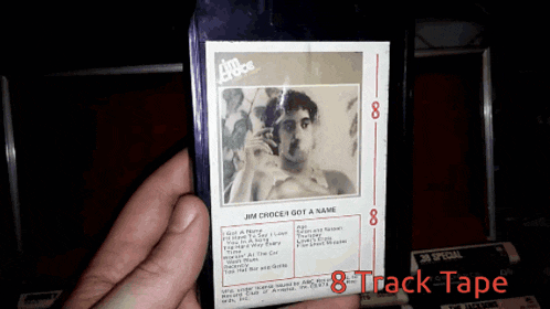 a person is holding a jim choice track tape with the number 8 on it