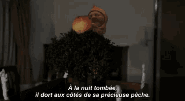 a cartoon character is sitting on a table with the words a la nuit tombée