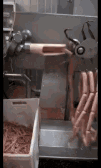 a bunch of sausages are being processed in a machine