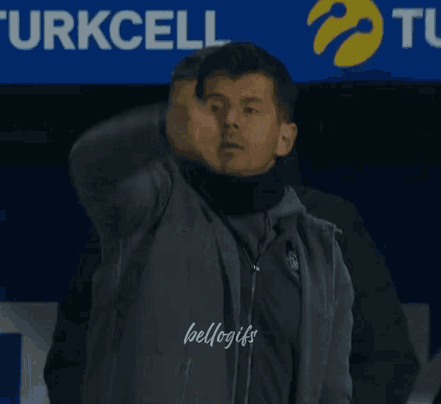 a man wearing a jacket that says turkcell on the front
