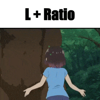 a girl in a blue shirt is standing in front of a large rock in a forest .
