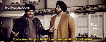 two men are standing next to each other and one of them is wearing a turban