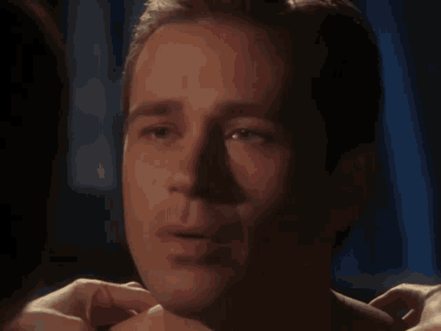 a close up of a man 's face with a woman 's hands on it