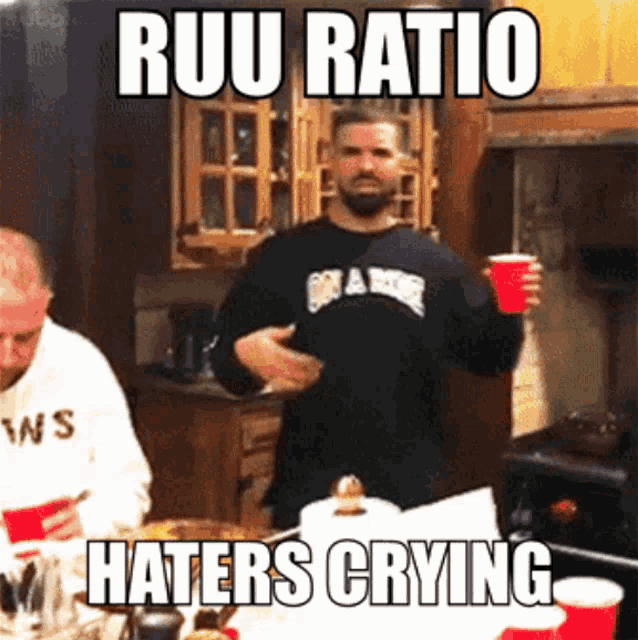 a man in a black shirt is holding a red cup and the caption reads ruu ratio haters crying