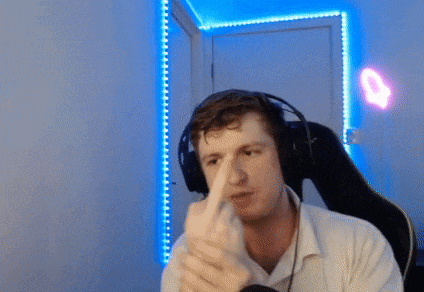 a man wearing headphones is sitting in a chair and making a funny face .