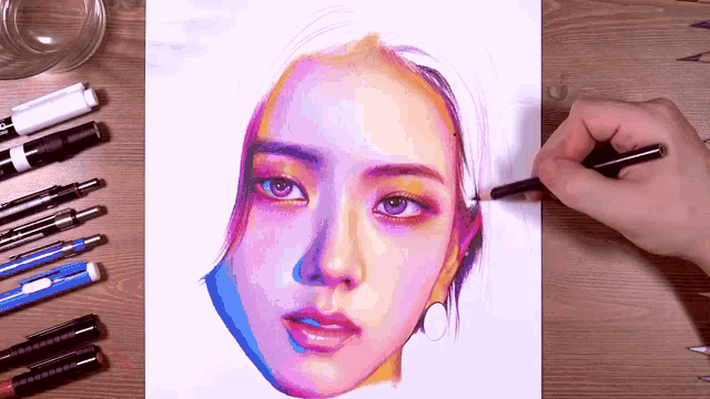 a person is drawing a woman 's face with a pencil on a piece of paper .