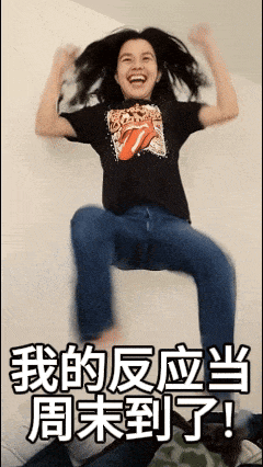 a girl wearing a black rolling stones shirt is jumping in the air