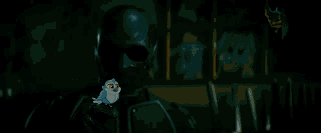 a man in a black helmet holds a small bird on his shoulder