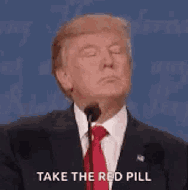 donald trump is talking into a microphone while wearing a suit and tie and says `` take the red pill '' .