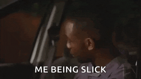 a man is sitting in the driver 's seat of a car with the words `` me being slick '' written on his face .