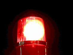 a close up of a red light with a yellow center