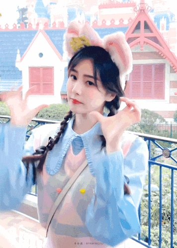 a girl with pigtails wearing a cat ear headband