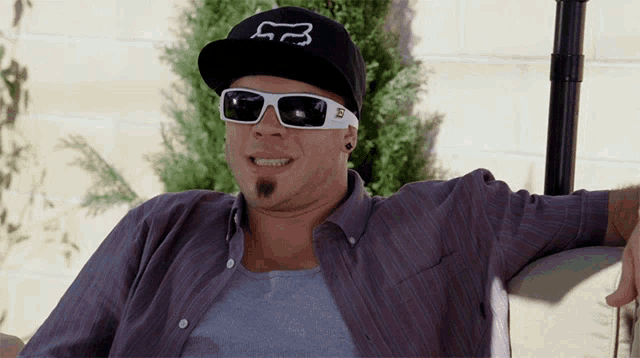 a man wearing a fox hat and sunglasses