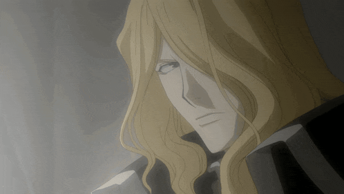 a man with long blonde hair and a black coat