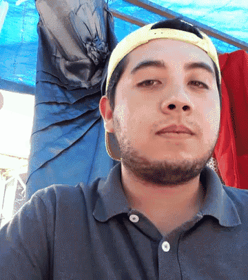 a man wearing a blue shirt and a yellow hat