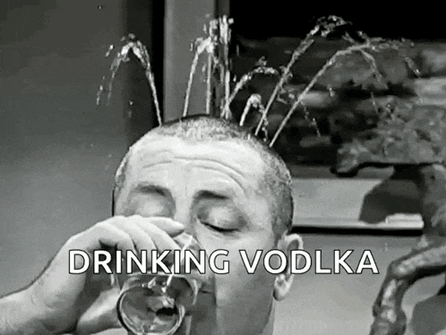 a man is drinking vodka from a glass with water spraying out of his head .