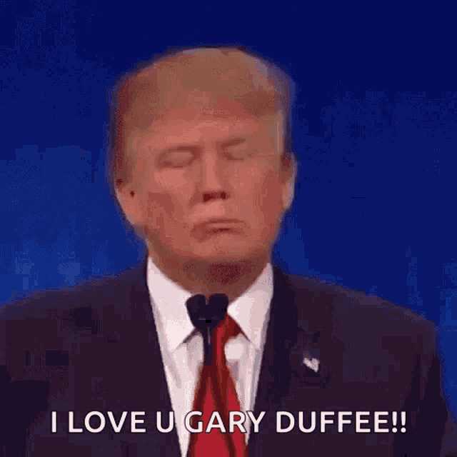 donald trump is making a funny face while speaking into a microphone .
