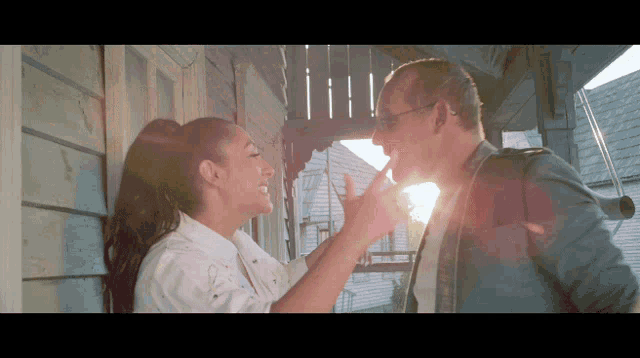 a man and a woman are holding hands and smiling